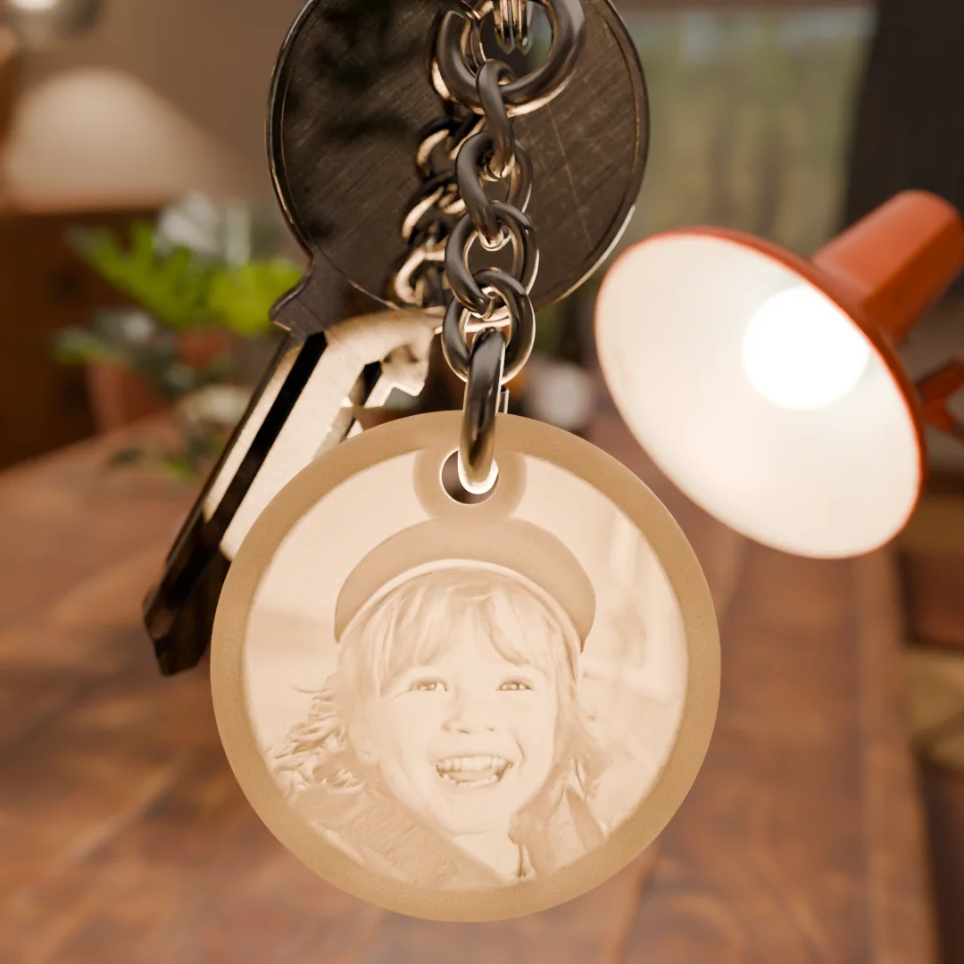 Glimery round photo keychain - in the light Glimery round photo keychain with a child’s portrait, backlit to reveal the photo.